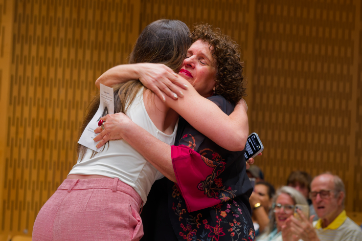 Melissa Watt, the first student to enroll in PS 89, embraces Najjar. “So much of my love for learning and confidence to pursue future opportunities really came from the foundation that she helped build,” Watt said. Photo: Carl Glassman/Tribeca Trib